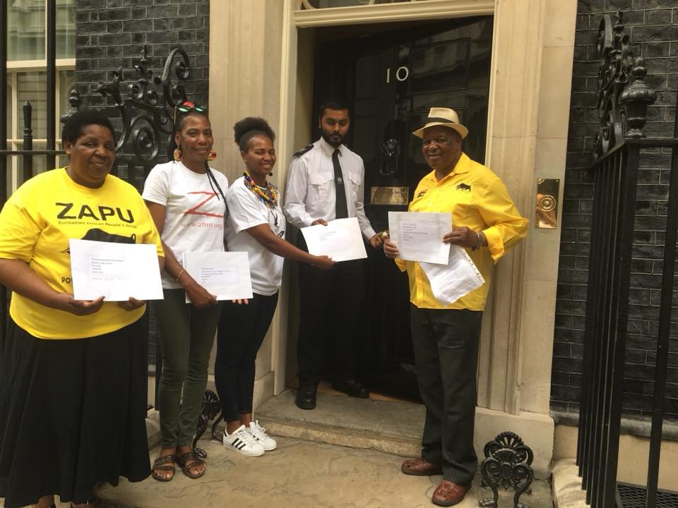 At the door to Number 10 Downing Street, London