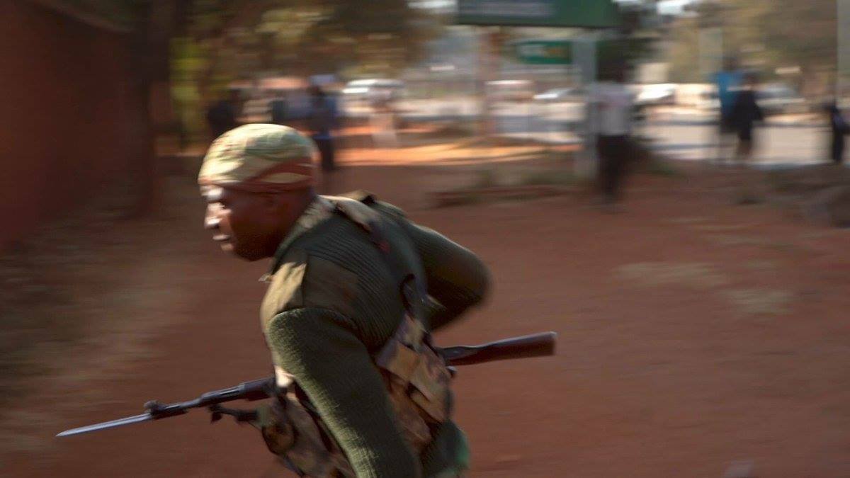 Soldier running with bayonet fixed and attacking civilians